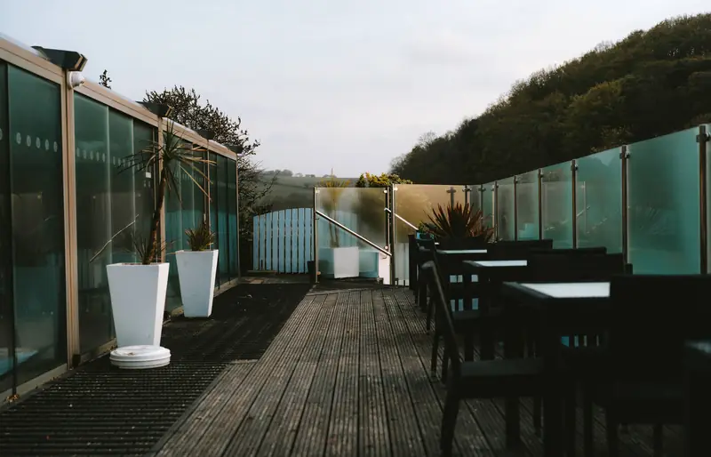 Glass-screened terrace at The Cove, Maenporth