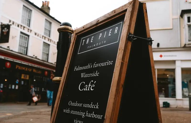 Sign for The Pier waterside cafe in Falmouth