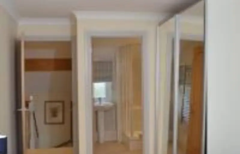 Landing with fitted mirrored wardrobes