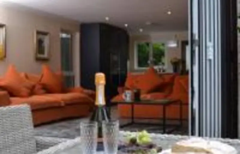Lounge with bifold doors opening onto the terrace