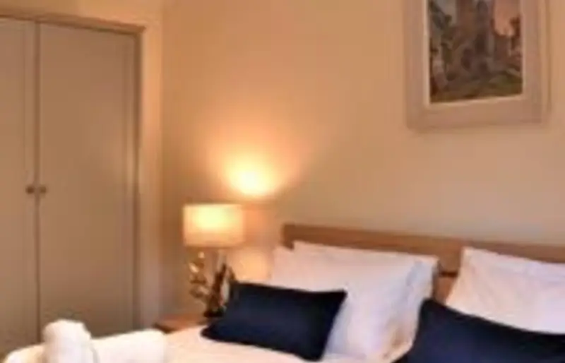 Master bedroom with double bed and bedside lamps