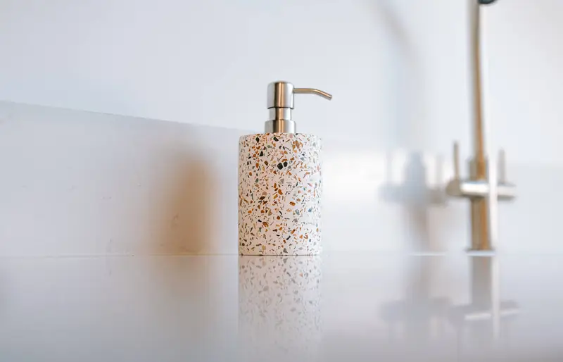 Soap dispenser beside the kitchen tap