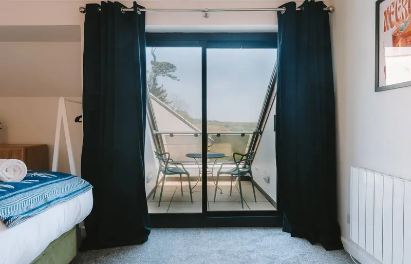 Main bedroom with doors opening onto a private balcony